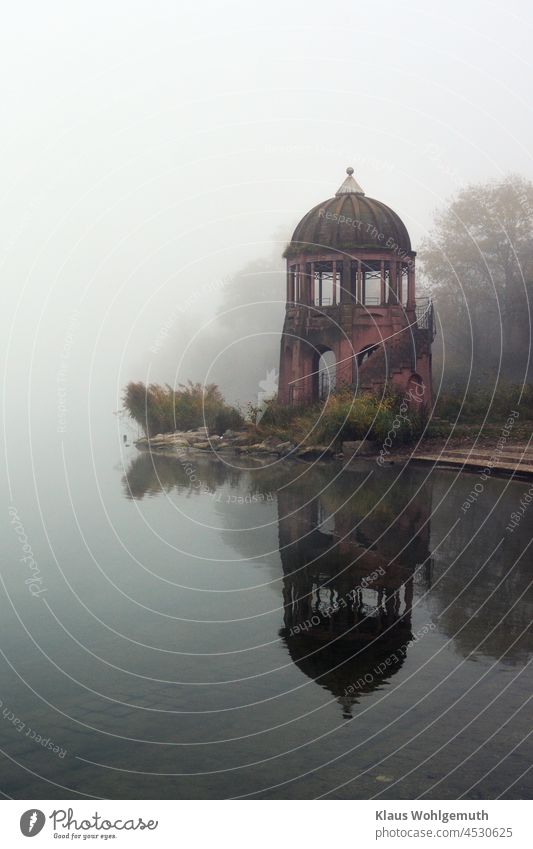 Temples at the Flückiger lake in Fribourg, in November fog, reflected in the water. Lake Flückiger Freiburg Rose garden Water Fog reflection daylight Gray Brown