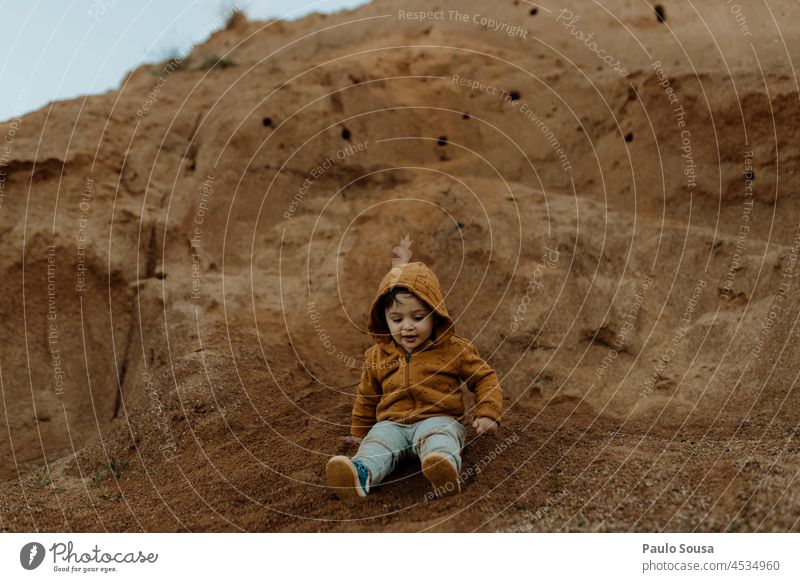 Child playing outdoors childhood 1 - 3 years Boy (child) Childhood memory Day Exterior shot Infancy Colour photo Joy Human being explore Environment Orange