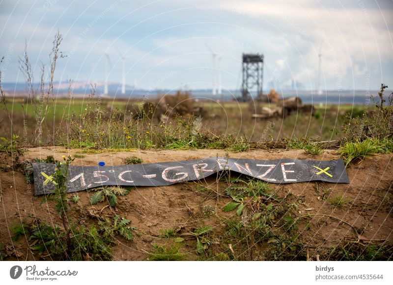 1.5 degrees - border, warning sign at the edge of the opencast lignite mine Garzweiler2 in NRW. All villages stay ! Soft coal mining Global warming coal exit