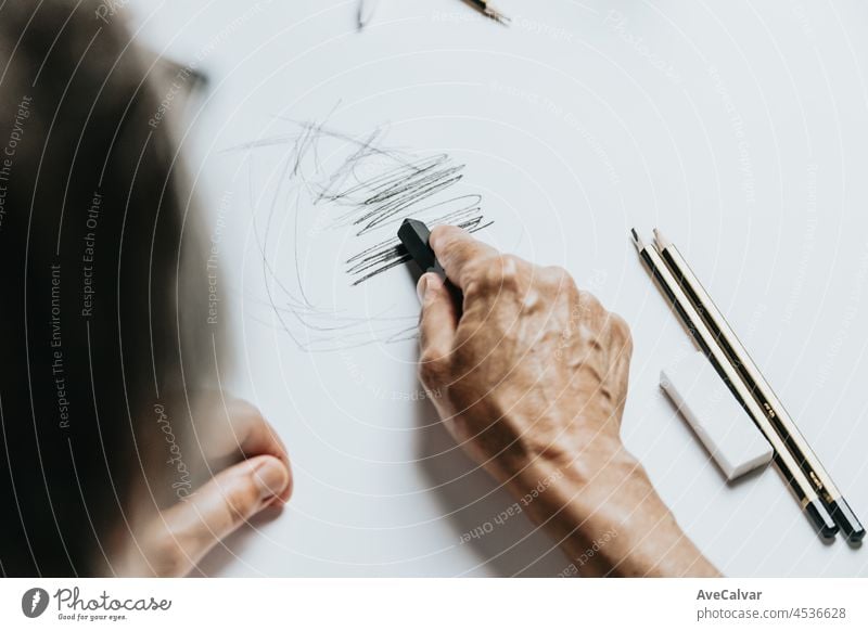 https://www.photocase.com/photos/4536628-high-angle-view-of-a-senior-caucasian-woman-drawing-sketches-in-studio-creativity-education-and-people-concept-cognitive-functions-clock-drawing-self-assessment-test-at-home-with-positive-results-photocase-stock-photo-large.jpeg
