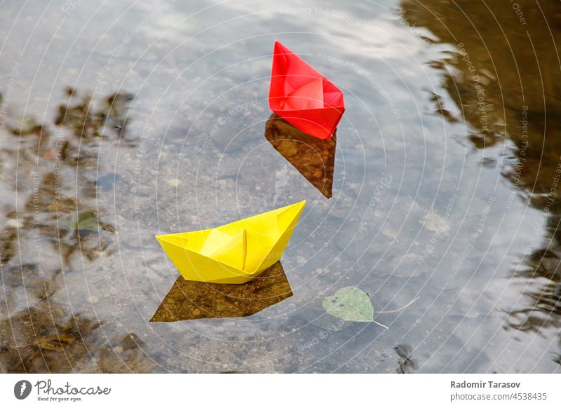 two multicolored paper boats floating on a stream - a Royalty Free Stock  Photo from Photocase