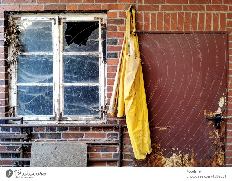 Hanging on the nail - is this yellow apron between the door and window of a losten dairy. lost place forsake sb./sth. Broken Old Transience Decline Change