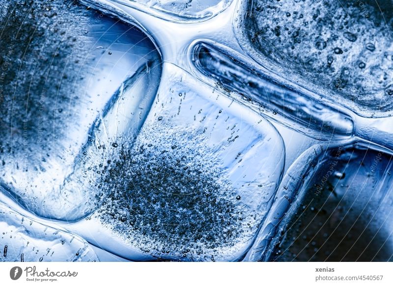 Macro image: Thin ice cubes with air bubbles in blue light - a Royalty Free  Stock Photo from Photocase