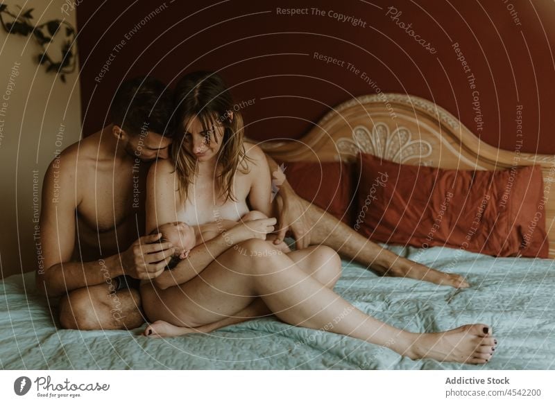 Happy Naked Couple With Baby Cuddling On Bed A Royalty Free Stock Photo From Photocase