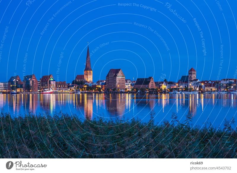 View over the Warnow river to the Hanseatic City of Rostock at the Blue Hour Warnov River city harbour Mecklenburg-Western Pomerania Town Church Petri church