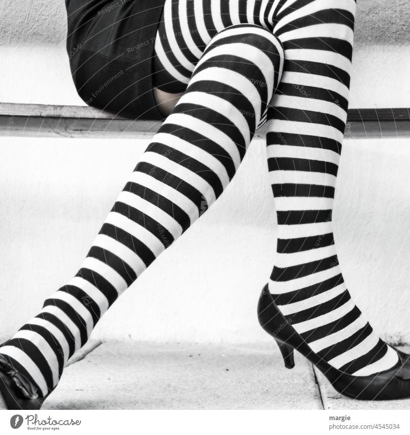 A woman with black and white striped stockings - a Royalty Free Stock Photo  from Photocase