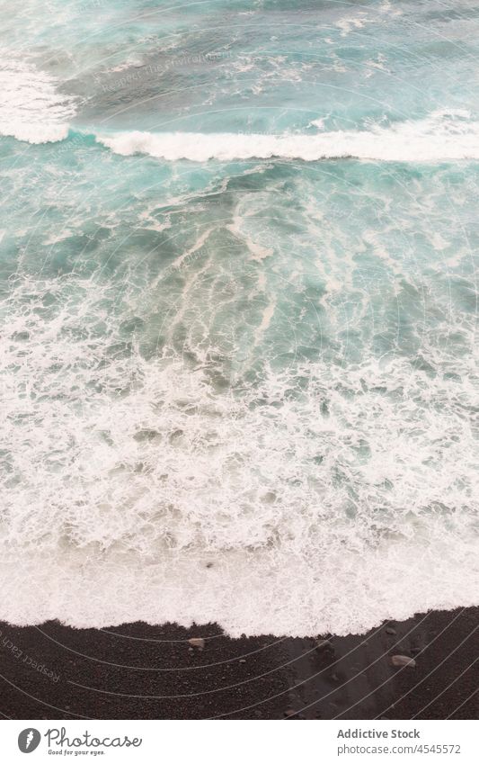 Foamy sea on dark sand wave foam shore water coast nature coastal seaside beach seashore coastline tide black ocean waterfront summer seafront aqua scene