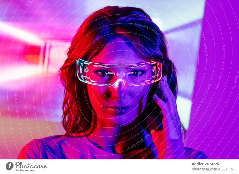 Young Woman In Projector Lights with led futuristic glasses projector bright color colorful confident videogame technology contemporary cool creative dark