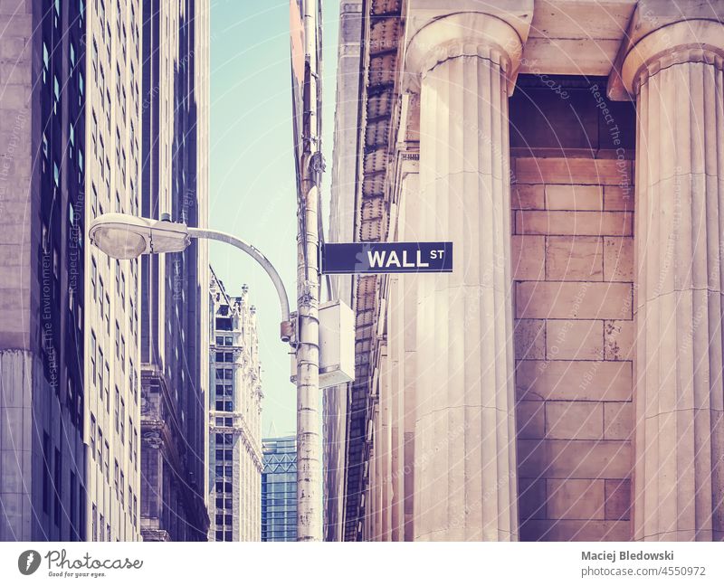 Color toned picture of Wall Street sign on a lamp post, selective focus, New York City, USA. city Manhattan business financial district street wall NYC symbol