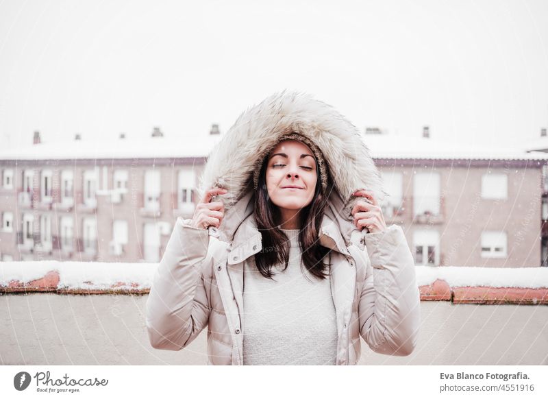 happy caucasian woman with eyes closed and arms outstretched standing on  snowy pier during winter by frozen lake. Winter lifestyle in nature - a  Royalty Free Stock Photo from Photocase