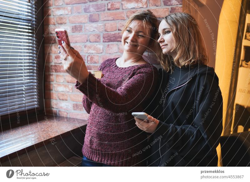 Women making video call on mobile phone.  Taking selfie photo using smartphone connection online remotely person chat internet smiling female happy technology