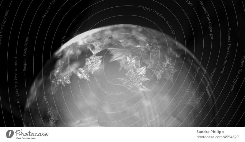 A frozen soap bubble against a dark background ice crystals Soap bubble Frost Cold Winter Ice Nature Exterior shot Deserted Macro (Extreme close-up) chill