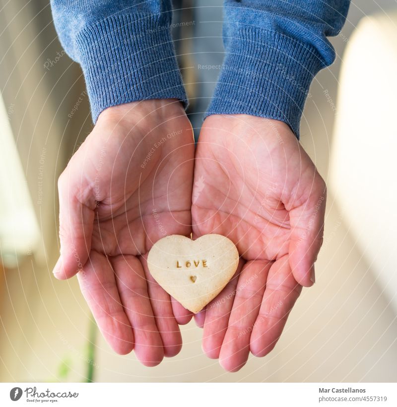 https://www.photocase.com/photos/4557319-hands-with-heart-shaped-cookie-letters-love-dot-photocase-stock-photo-large.jpeg