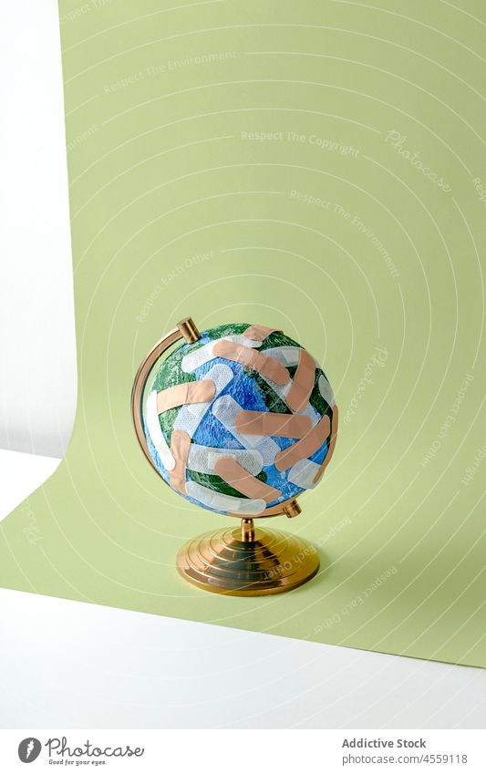 Globe of Planet Earth stuck with numerous band aids globe planet earth sphere global concept protect environment ecology small continent geography save world