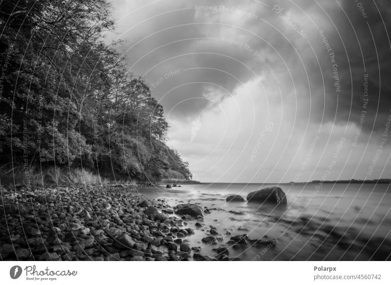 Pebbles by the shore in cloudy weather pebbles scenery sunrise dark horizon environment seascape peaceful rocks smooth moody poster tranquil idyllic sunlight bw