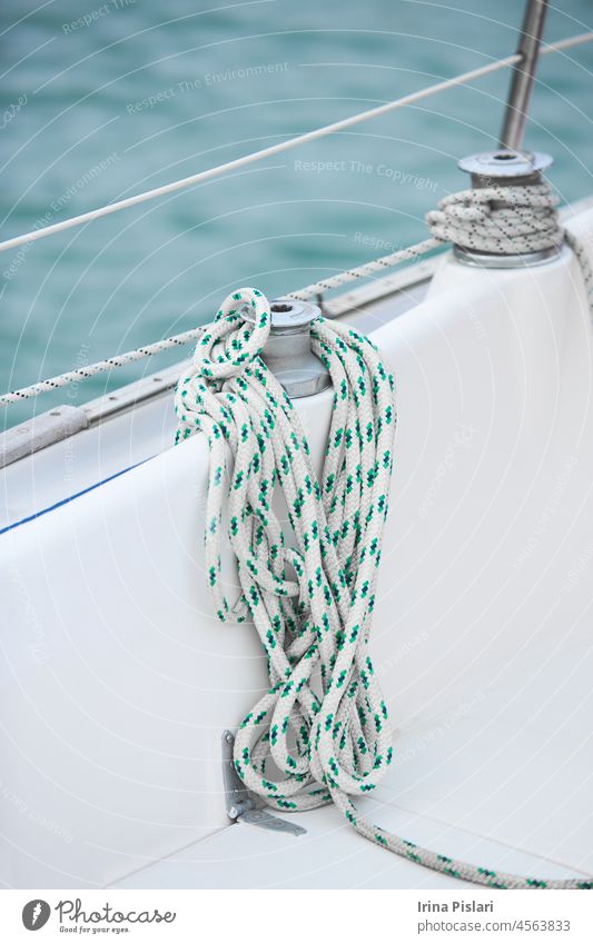 Winch and nautical ropes on a sailing boat in the port ancient block boating boom cable closeup cord crank cruise deck detail dock equipment handle hoist knot