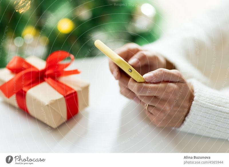 Young woman Paying online during holiday shopping. Person using modern technology. online shopping christmas new year mobile phone sale gift computer internet