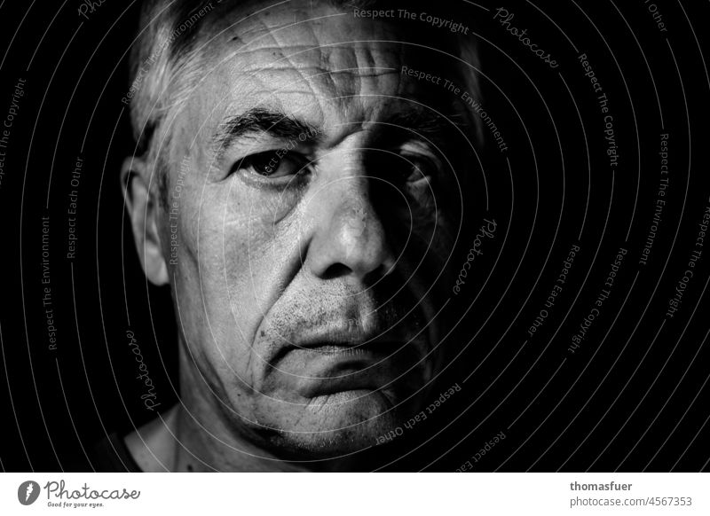 Portrait of man in darkness, serious Man portrait Human being Black & white photo Face Adults Close-up Face of a man Looking into the camera Contrast crease