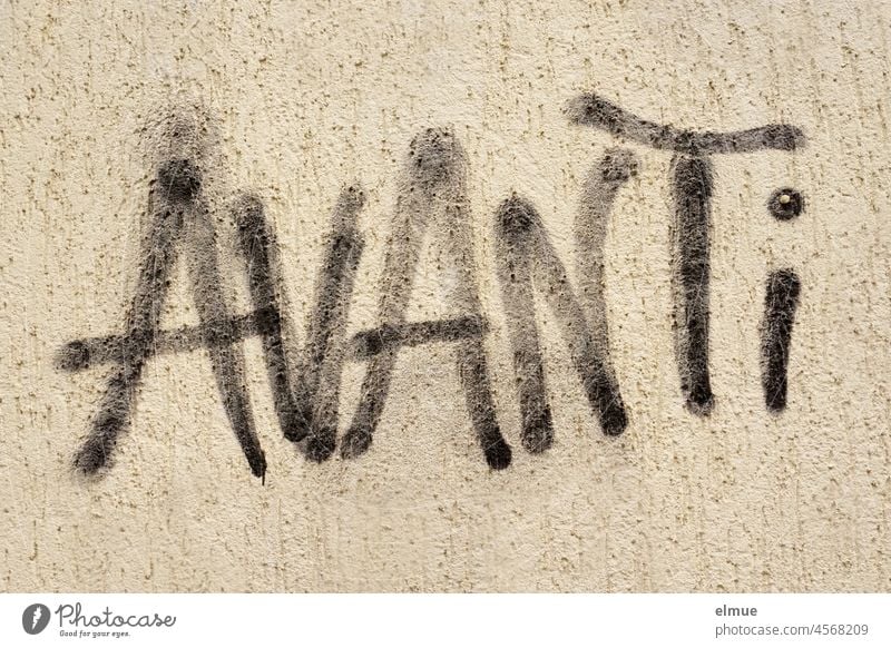 AVANTi is sprayed in black on the house wall / Graffito Avanti Italian Forwards Graffiti Black lettering Plaster Facade Daub Street art Communication