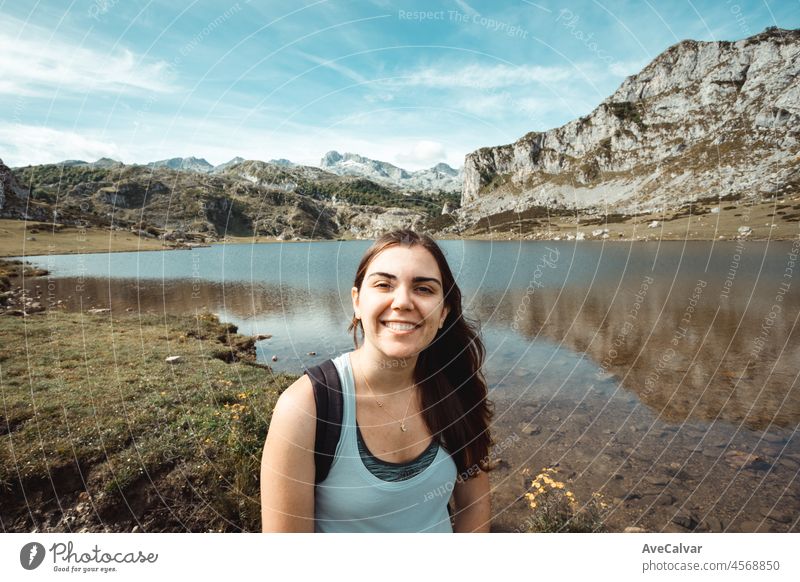 Young woman portrait on the mountains after a travel day. Idyllic scenario views of the spanish mountains celebrating life. Resting after a day of walking copy space for add