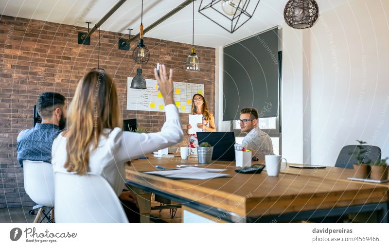 African American business woman standing in front of her team in office - a  Royalty Free Stock Photo from Photocase