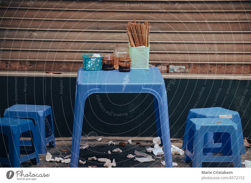 Blue plastic chairs and table on the side street of Hanoi City serving traditional pho bo or beef noodle soup copy space indochina city town travel hanoi