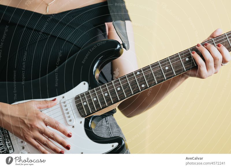 Close up of a young woman pair of hands playing a guitar outdoors. Sunny day and practicing an instrument concept. Copy space music life on tour and nature.