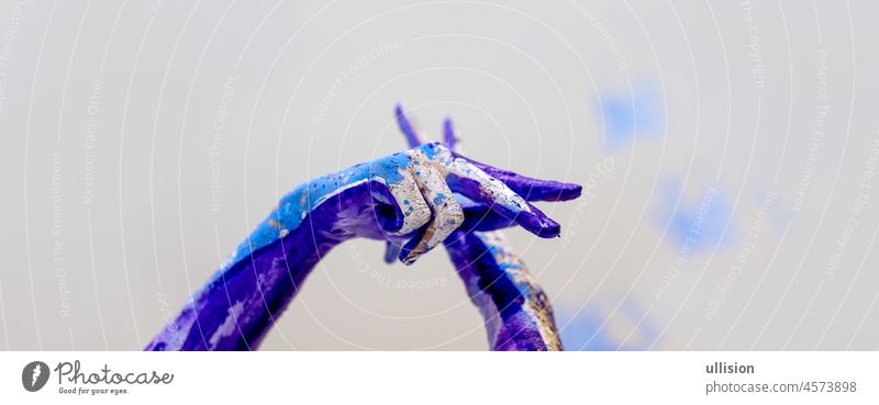 beautiful hands of a young artistically abstract painted woman, ballerina with white, blue and purple, violet paint, Creative body art painting creative