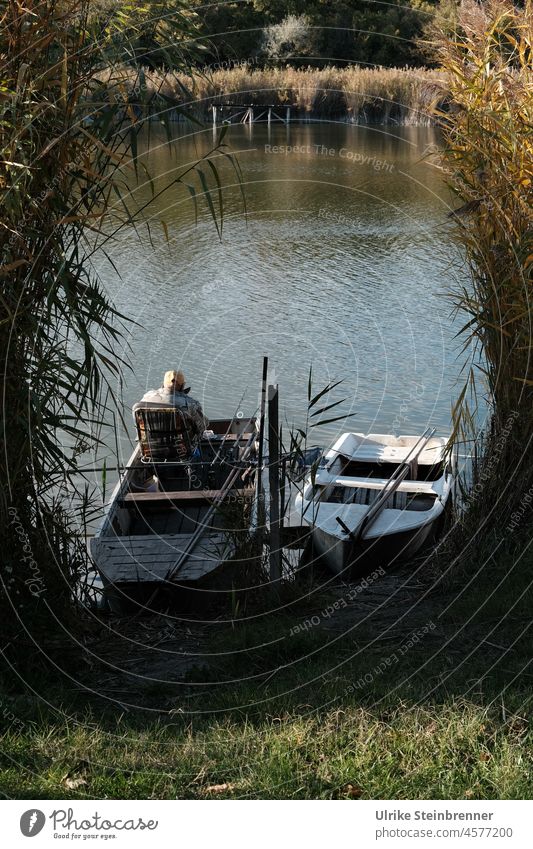 Angler in boat at Szelid lake in Hungary Fishing boat Fisherman fishing Man free time recreational sport bank Lake reed Hiding place Berth Nature reserve