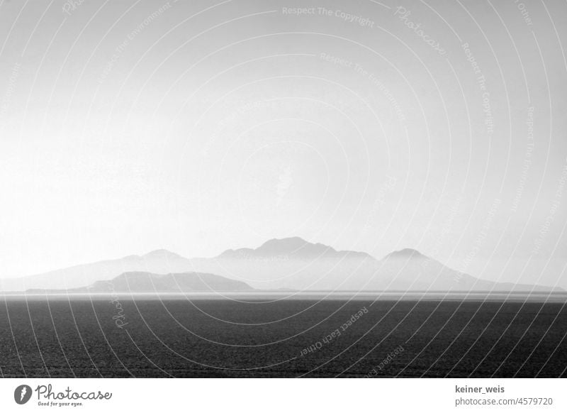 An island in the sea disappears in the fog Island Ocean Fog ocean Lake mountains Hill Landscape Black & white photo black-and-white Grayscale Greece the Aegean