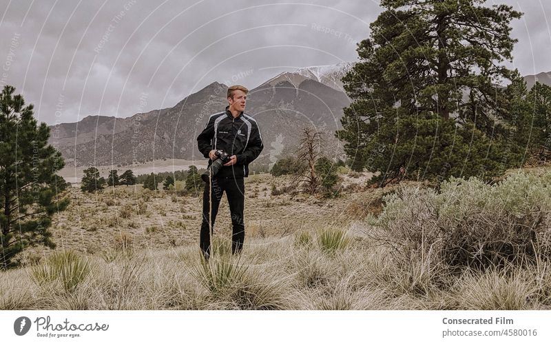 Man walking in the forest with camera, taking photographs Photographer Photography Take a photo Camera Sky Mountains Clouds Travel Adventure