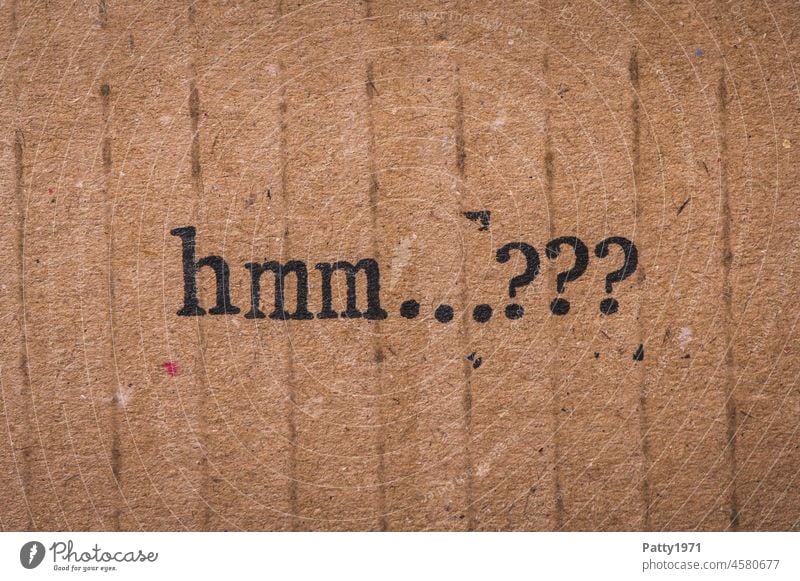 Stamped text on cardboard. hmm...??? Question mark question Perplexed indecisiveness Cardboard paperboard Paper Old Grunge Brown Text Characters Irritation