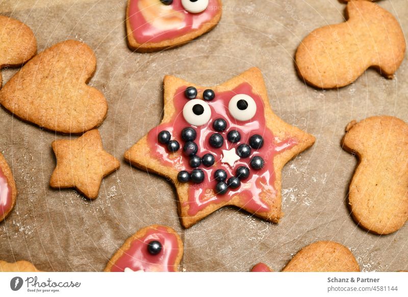 Star shaped Christmas cookie with eyes and icing Starry Icing cookie dough outdo sb. Stars fir tree christmas time Spoon Face Hand baking paper Fingers Cookie