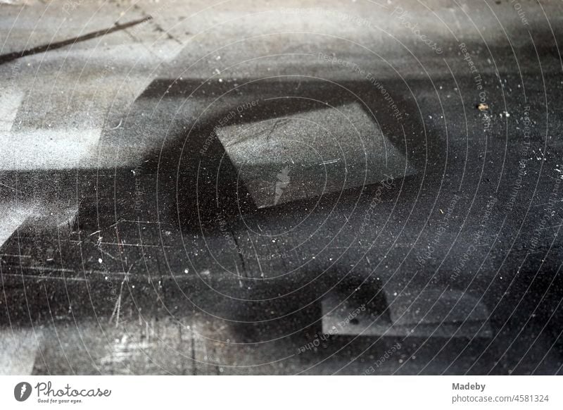 Geometric figures and stencils in black and shades of grey as residues of spray cans on a surface in front of an old workshop in the Margaretenhütte district of Gießen on the Lahn in Hesse