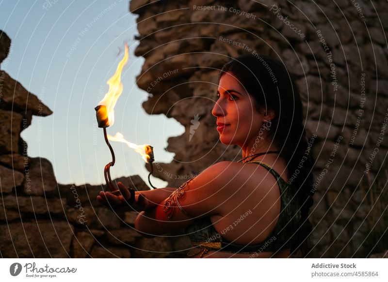 Woman with fire fans in evening woman dancer perform entertain show practice talent city skill flame medieval village amusement burn effect bright spark fiery