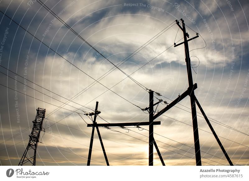 Electricity transmission pylon view against the sky during sunset. geometry direction cable wire power supply station distribution beauty natural nature eco