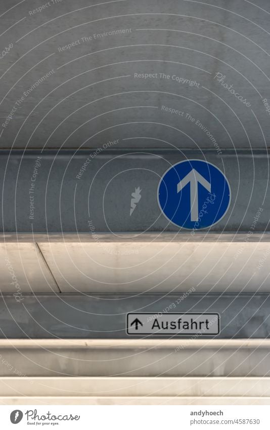 Traffic sign with direction of travel straight ahead and exit architecture arrow Arrows attention blue ceiling choice concept conceptual concrete construction