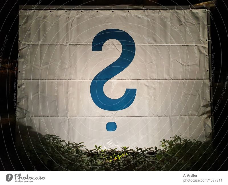 blue question mark ? on a tarpaulin in the foreground plants Question mark tarpaulin Ask Perplexed Puzzle Irritation Insecure concept Education Characters