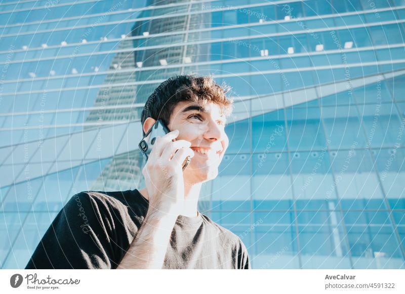 Young business man going to work receiving calls in front of a office building in city outdoors. Copy space mobile phone businessman male people technology bank