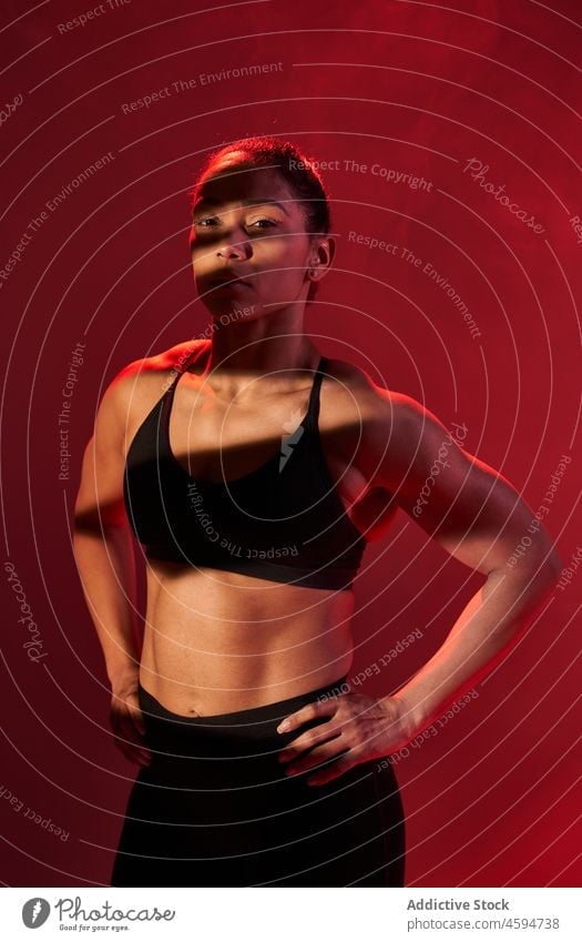 Fit woman sanding hands on hips while training - a Royalty Free Stock Photo  from Photocase