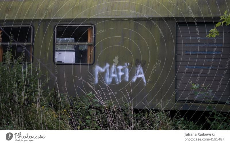 old abandoned wagon with the word mafia sprayed on it Graffiti Tagger Smeared writing Characters Letters (alphabet) Green Day Tagging (graffiti) Vandalism Spray