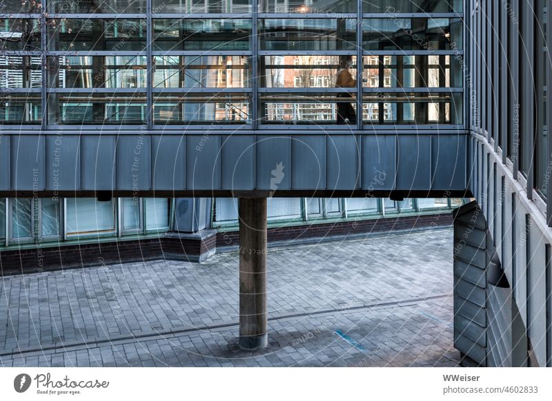 An unrecognizable woman walks busily through the passage between two office buildings Office House (Residential Structure) Building Architecture Intersection