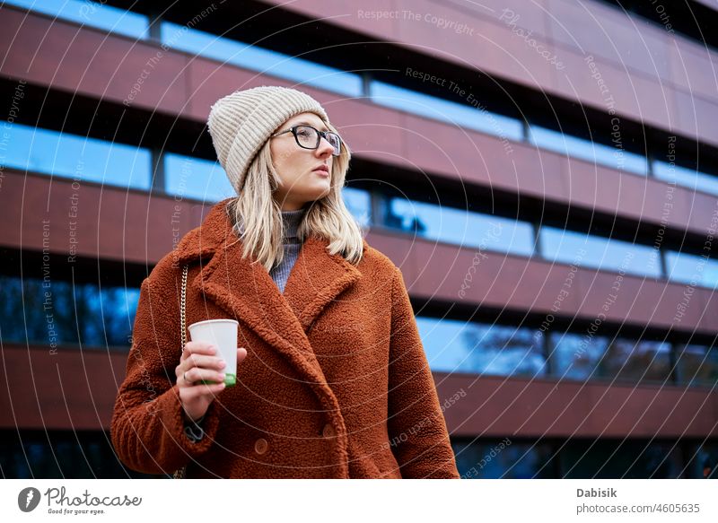 Woman at city street with coffee cup woman walking lifestyle urban eyeglasses crosswalk drink fashion business takeaway city life girl model road casual lady