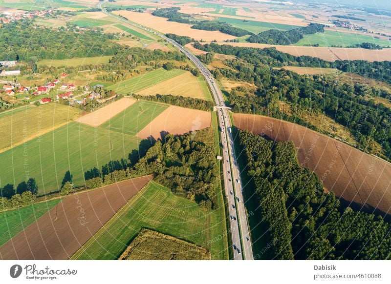 Aerial view of highway with moving cars. Road traffic road transport aerial travel transportation logistic asphalt landscape tree background top street country