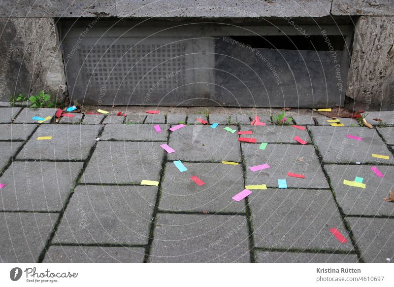 colorful confetti snippets lie on the sidewalk in front of a basement window Confetti Paper Snippets paper shavings Scrap of paper variegated colored Carnival