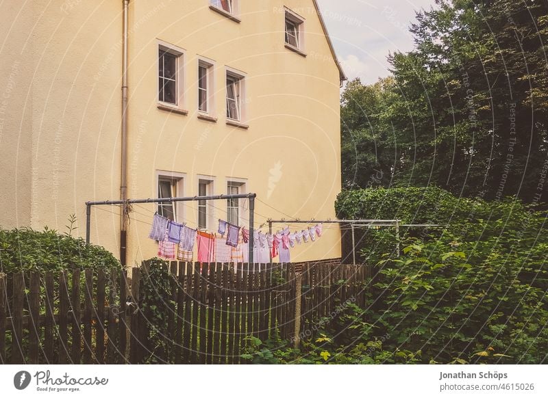 pink and purple laundry on the clothesline in the garden Laundry Pink Garden House (Residential Structure) Fence Facade dry laundry hanging up laundry Washing