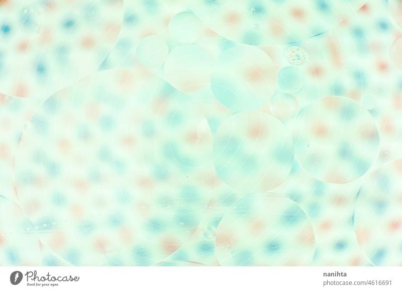 A beautiful and colorful macro of oil bubbles on water with blur of red and blue dots on white as background with vintage filter abstract wallpaper resource