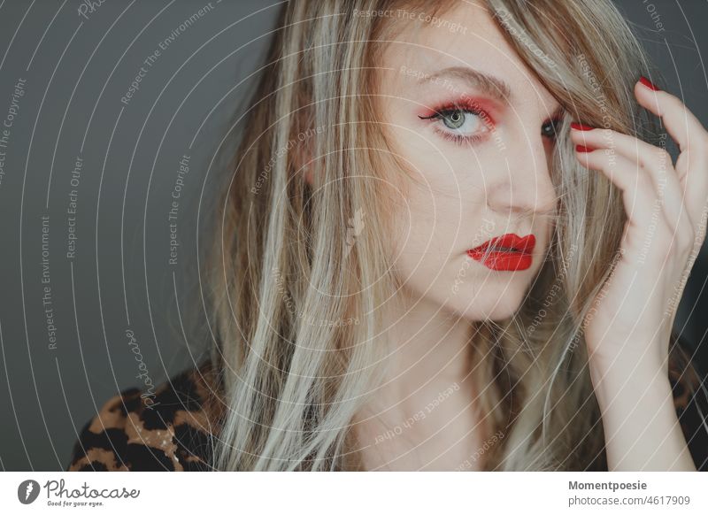woman Blonde Red pretty Modern timid Looking away Observe look at Insecure insecurity communication Communicate Long-haired Wearing makeup red lips Lips