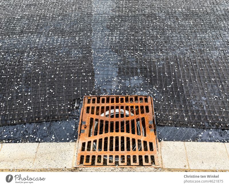 Rusty sewer grate. Road rehabilitation. The asphalt surface is still missing. Channel grille Gully Grating Street Drainage Drainage system Structures and shapes
