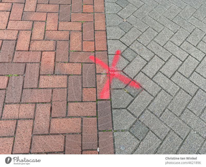 Red sprayed X at the transition from red to gray paved area red X Crucifix ticked off Signs and labeling Paving stone Structures and shapes Street Pattern